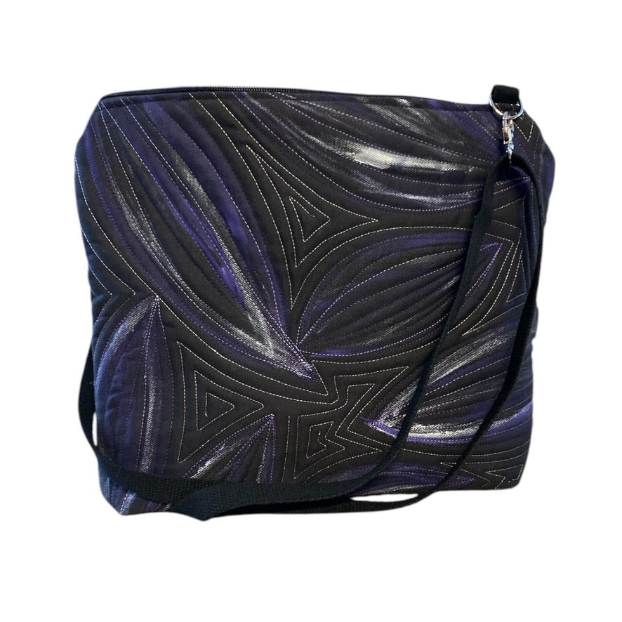 A unique art bag with a hand-painted leaf pattern and free motion quilting